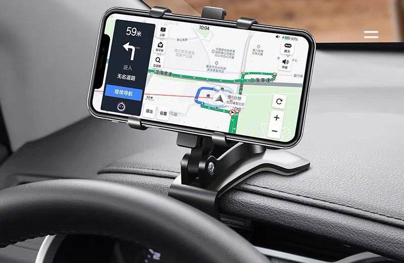 
                  
                    Universal snap-in dashboard phone holder securely holding a mobile device in a car, featuring multifunctional support for navigation.
                  
                
