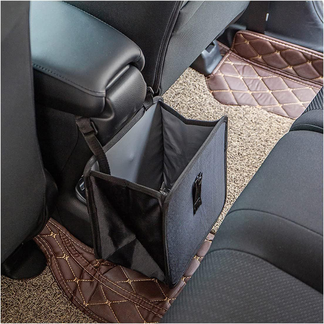 Black waterproof folding rear seat trash can hanging in a car.