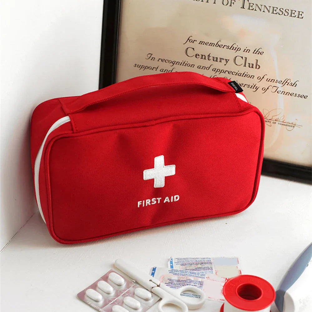 Red emergency medical first aid kit with items, featuring waterproof fabric and a handle, ideal for outdoor and home use.