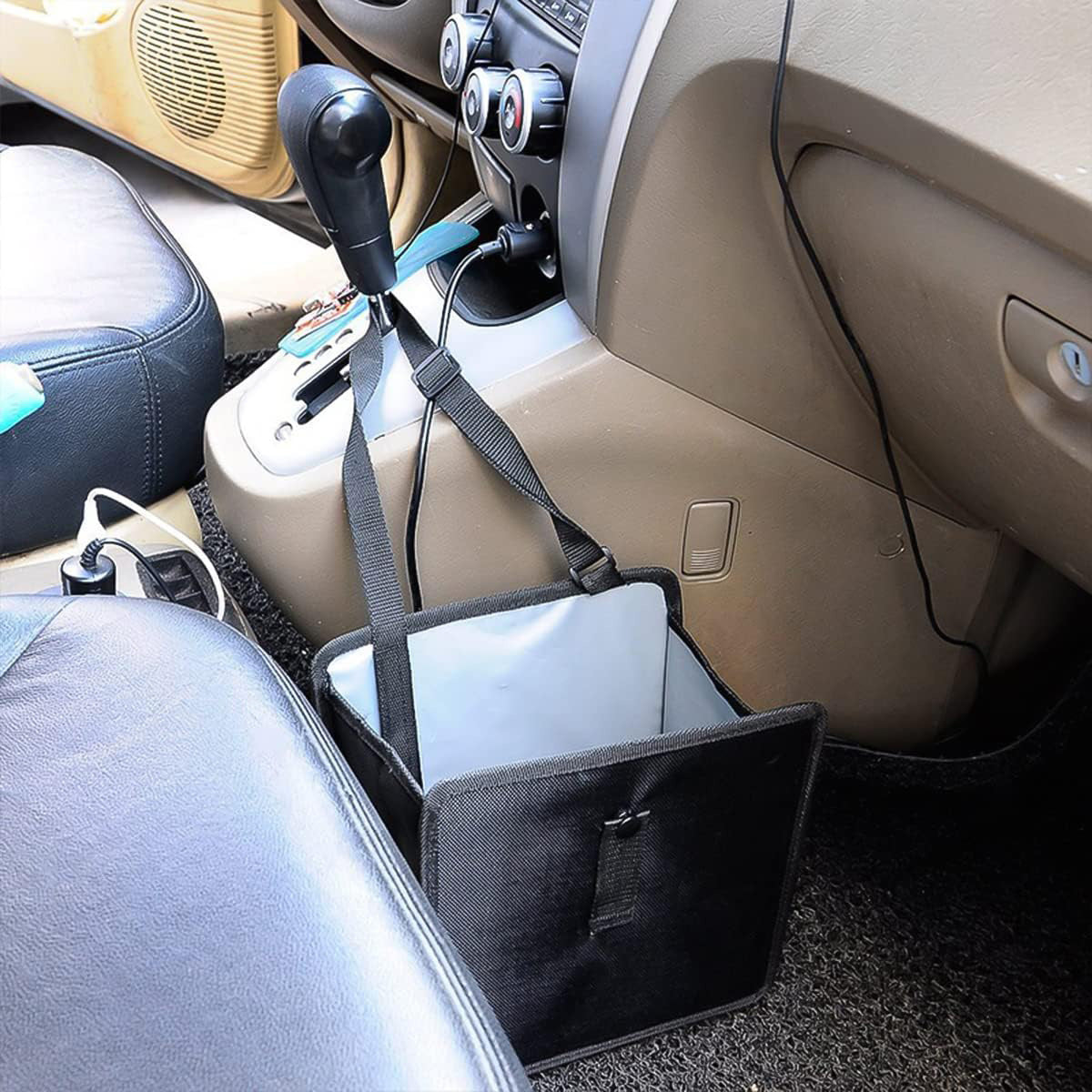 Large capacity folding rear seat trash can in black oxford cloth hanging in vehicle.