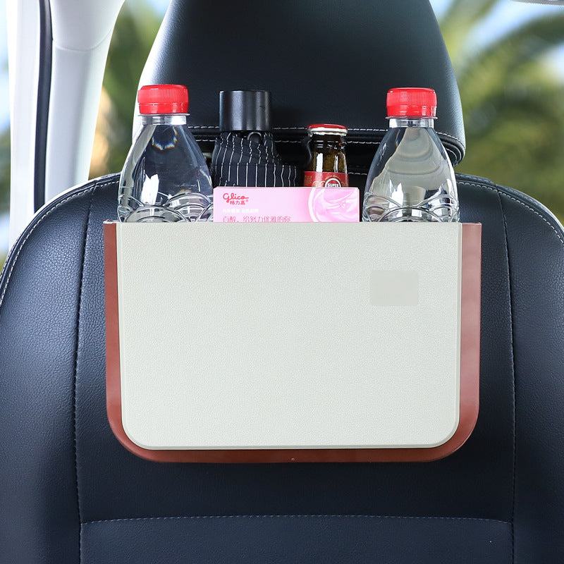 
                  
                    Foldable seatback hanging storage container holding bottles and items in a car.
                  
                
